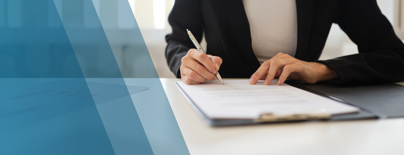 A woman signing a document